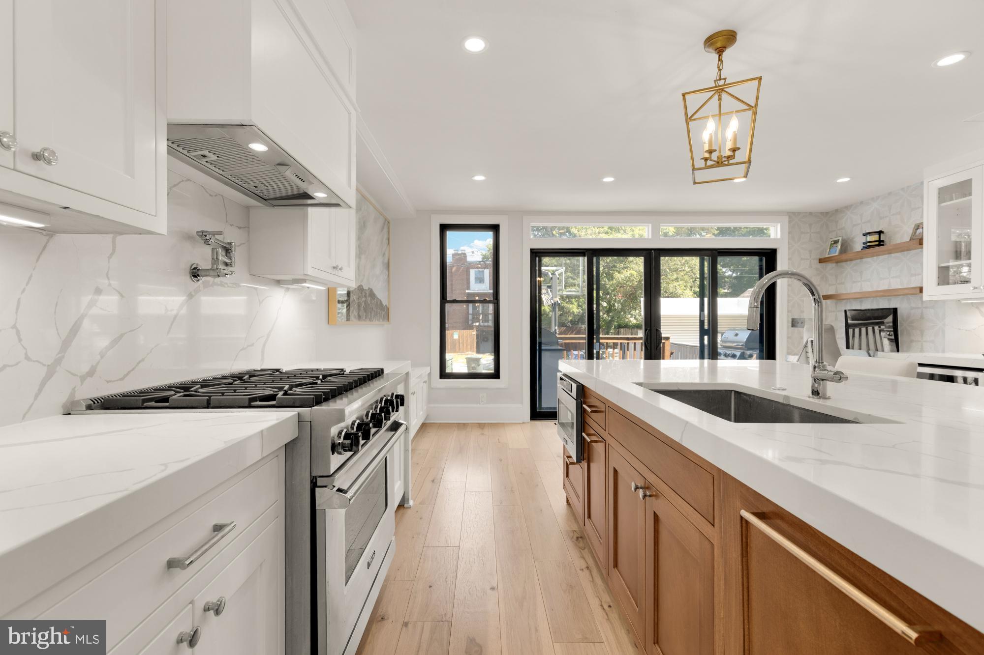 3705 Reservoir Road Northwest Washington, DC 20007 - Photo 13 of 45 a kitchen with granite countertop a sink and a stove top oven