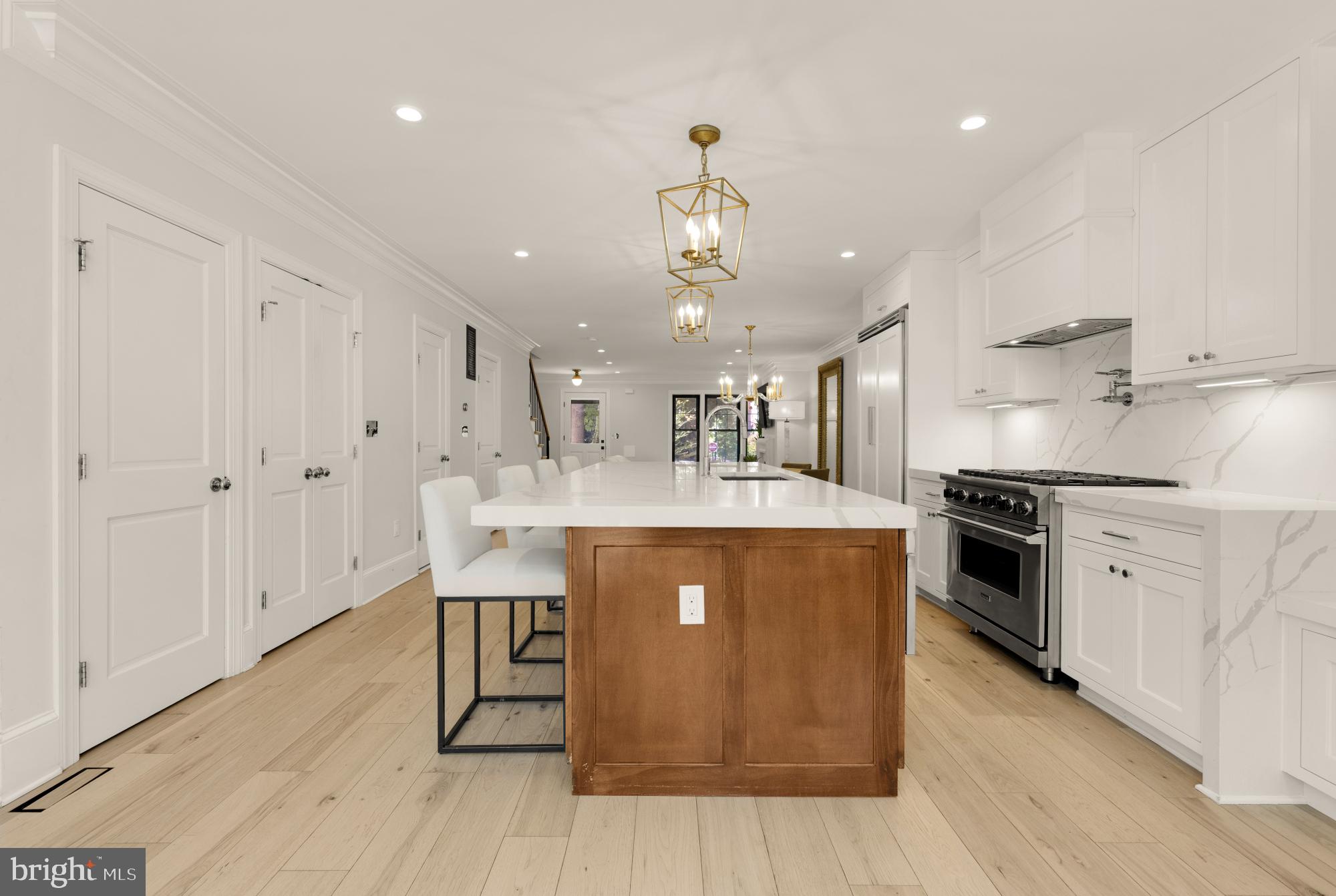 3705 Reservoir Road Northwest Washington, DC 20007 - Photo 19 of 45 a large kitchen with stainless steel appliances granite countertop a stove a sink dishwasher and a refrigerator with wooden floor