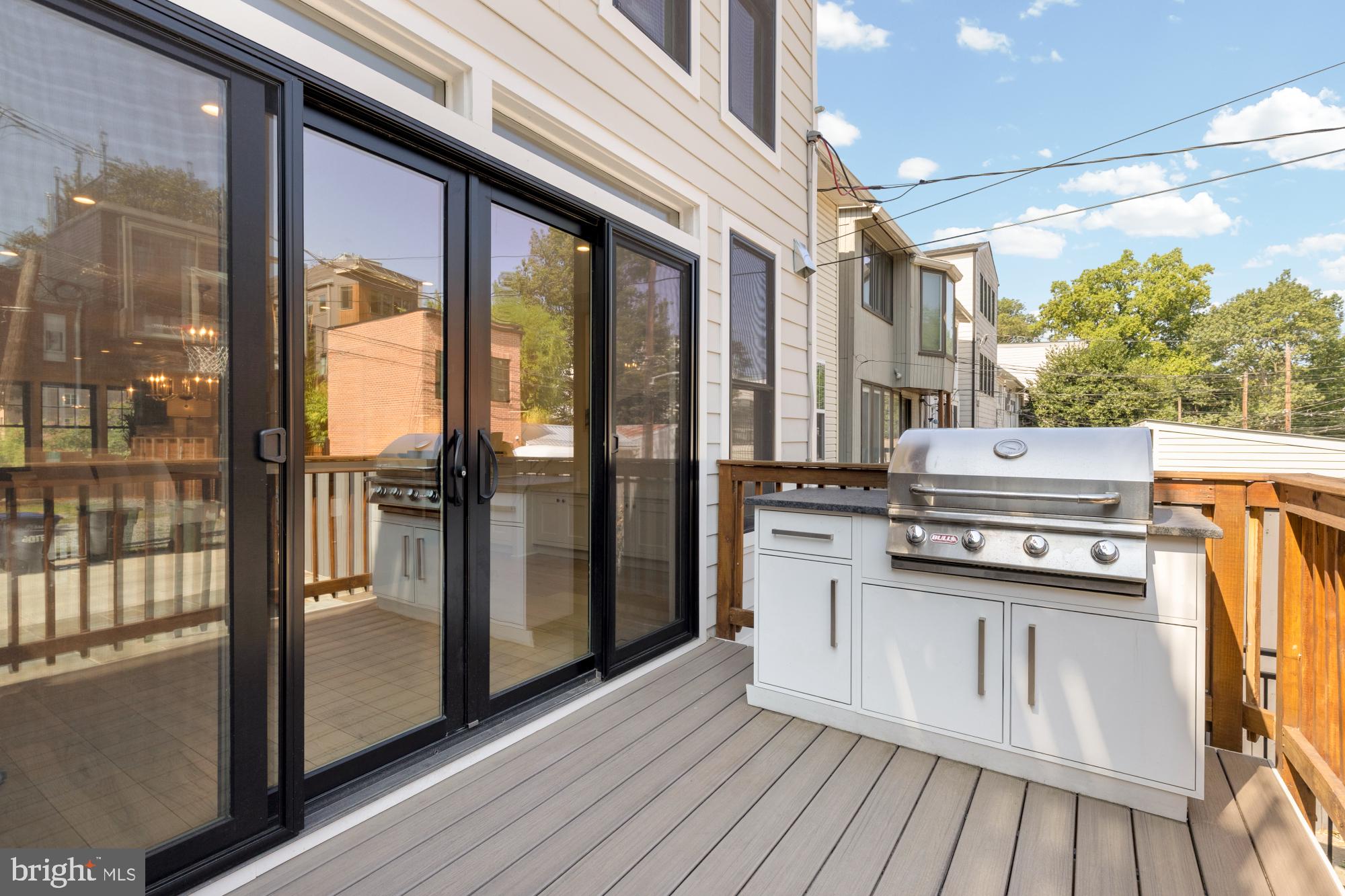 3705 Reservoir Road Northwest Washington, DC 20007 - Photo 23 of 45 a kitchen with stainless steel appliances granite countertop a refrigerator a stove and a wooden floors