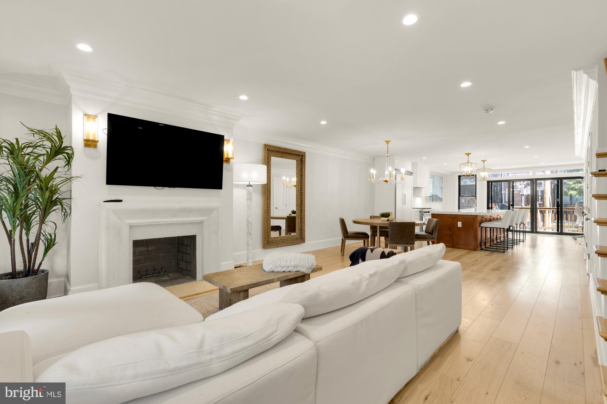 3705 Reservoir Road Northwest Washington, DC 20007 - Photo 3 of 45 a living room with furniture a fireplace and a flat screen tv