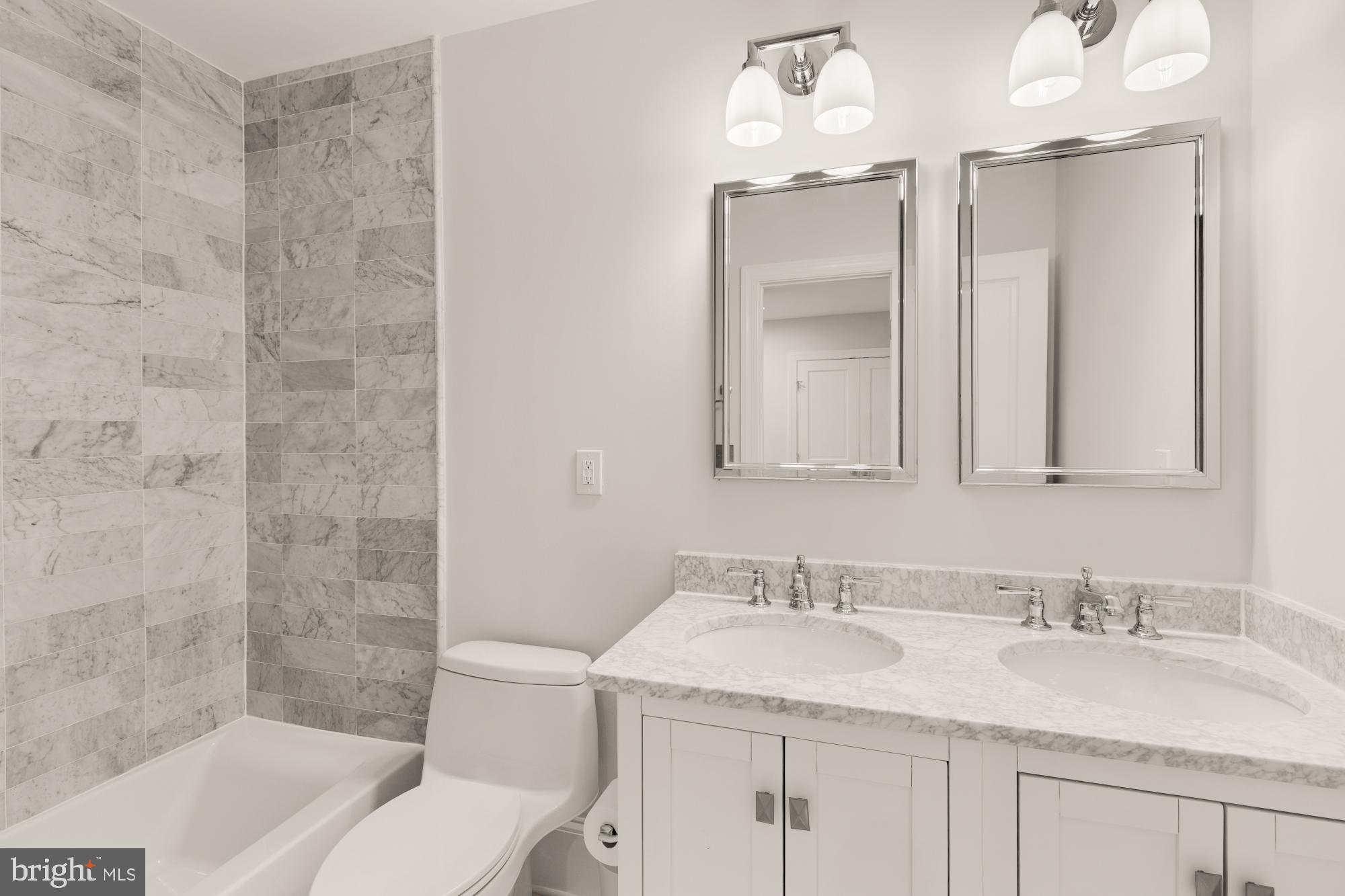 3705 Reservoir Road Northwest Washington, DC 20007 - Photo 34 of 45 a bathroom with a granite countertop sink mirror and a bathtub