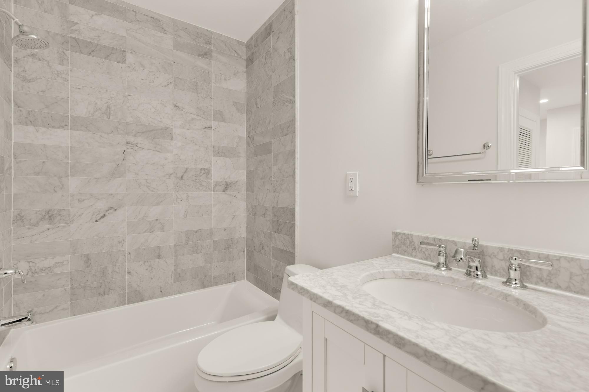 3705 Reservoir Road Northwest Washington, DC 20007 - Photo 35 of 45 a bathroom with a granite countertop sink toilet and shower