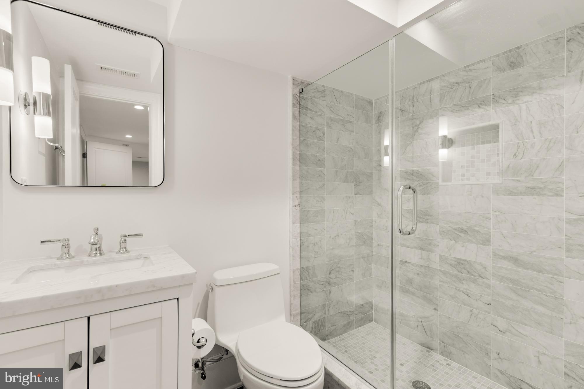 3705 Reservoir Road Northwest Washington, DC 20007 - Photo 42 of 45 a bathroom with a shower a sink a toilet and mirror