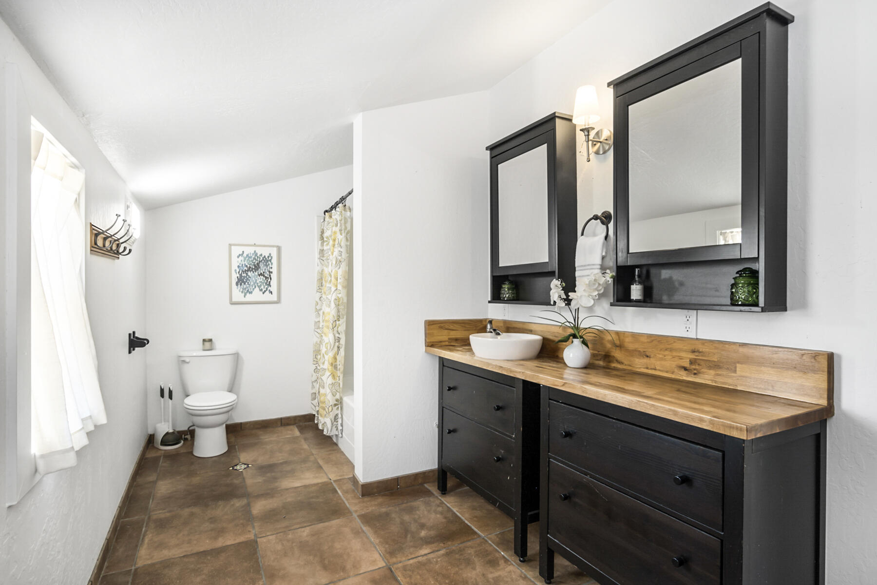 65515 Cline Falls Road Bend, OR 97703 - Photo 33 of 57 a bathroom with a sink and mirror with toilet