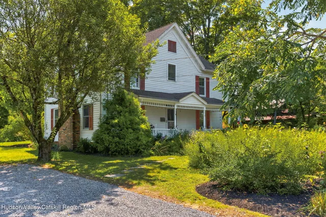 a view of a house with swimming pool next to a yard
