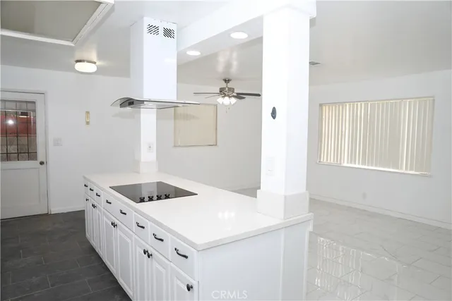 a kitchen with white cabinets and white appliances