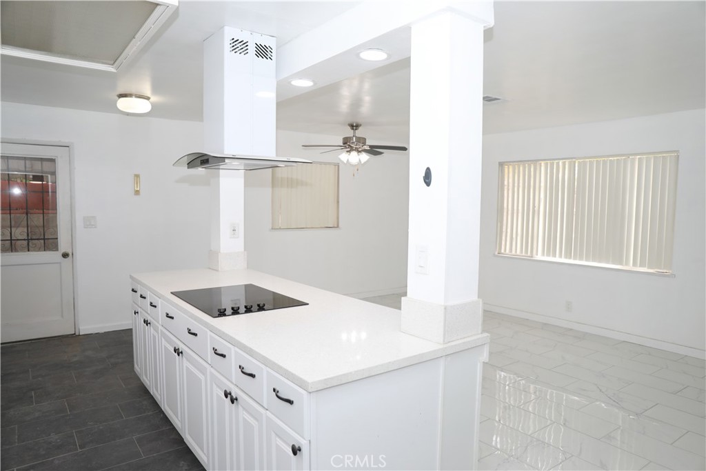 38626 Frontier Avenue Palmdale, CA 93550 - Photo 2 of 13 a kitchen with white cabinets and white appliances