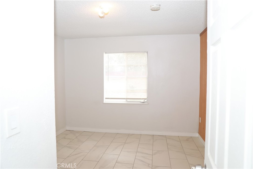38626 Frontier Avenue Palmdale, CA 93550 - Photo 5 of 13 a view of an empty room with a window
