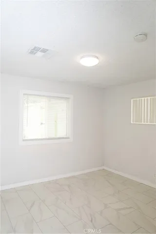 an empty room with a empty space and a window