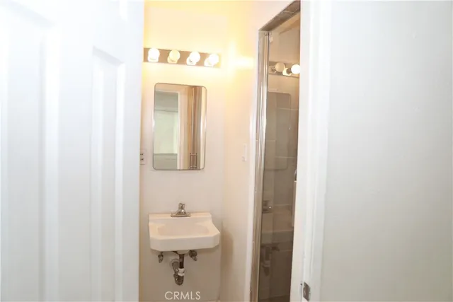 a bathroom with a sink and mirror