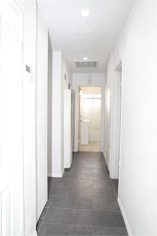 a view of a room with door and hallway