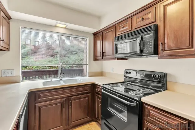 a kitchen with a stove microwave and sink