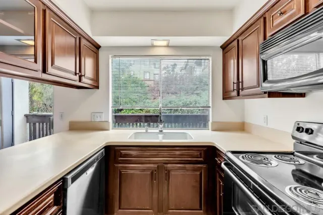a kitchen with granite countertop a stove and a sink