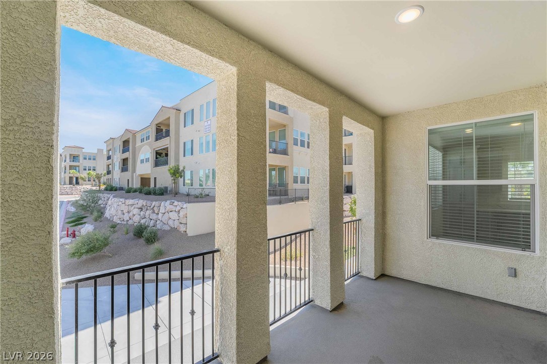 2555 Hampton Road, Unit 10202 Henderson, NV 89052 - Photo 20 of 35 Stucco pillars and metal railings frame pleasant neighborhood views from this private covered balcony.
