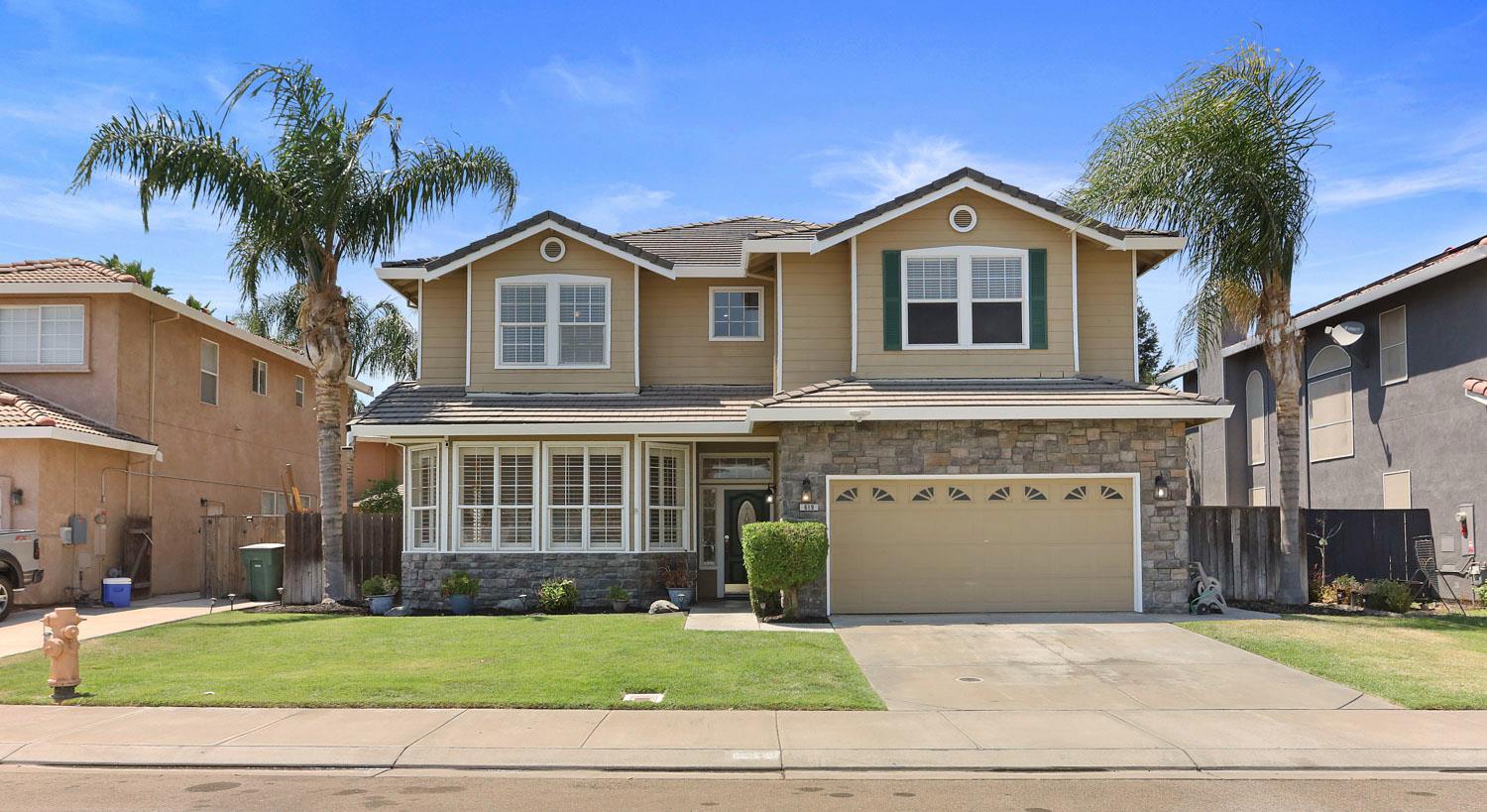 619 Pecan Drive Ripon, CA 95366 - Photo 1 of 1 a front view of a house with a yard and garage