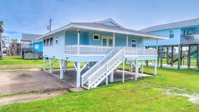 a view of a house with a yard and furniture
