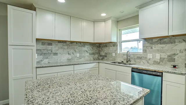 a kitchen with stainless steel appliances granite countertop a sink stove and cabinets