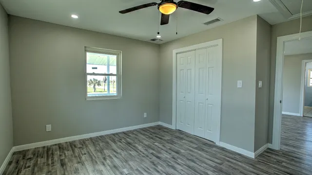 wooden floor in an empty room with a window
