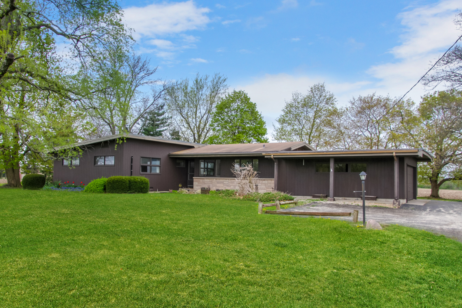 a front view of house with yard and trees