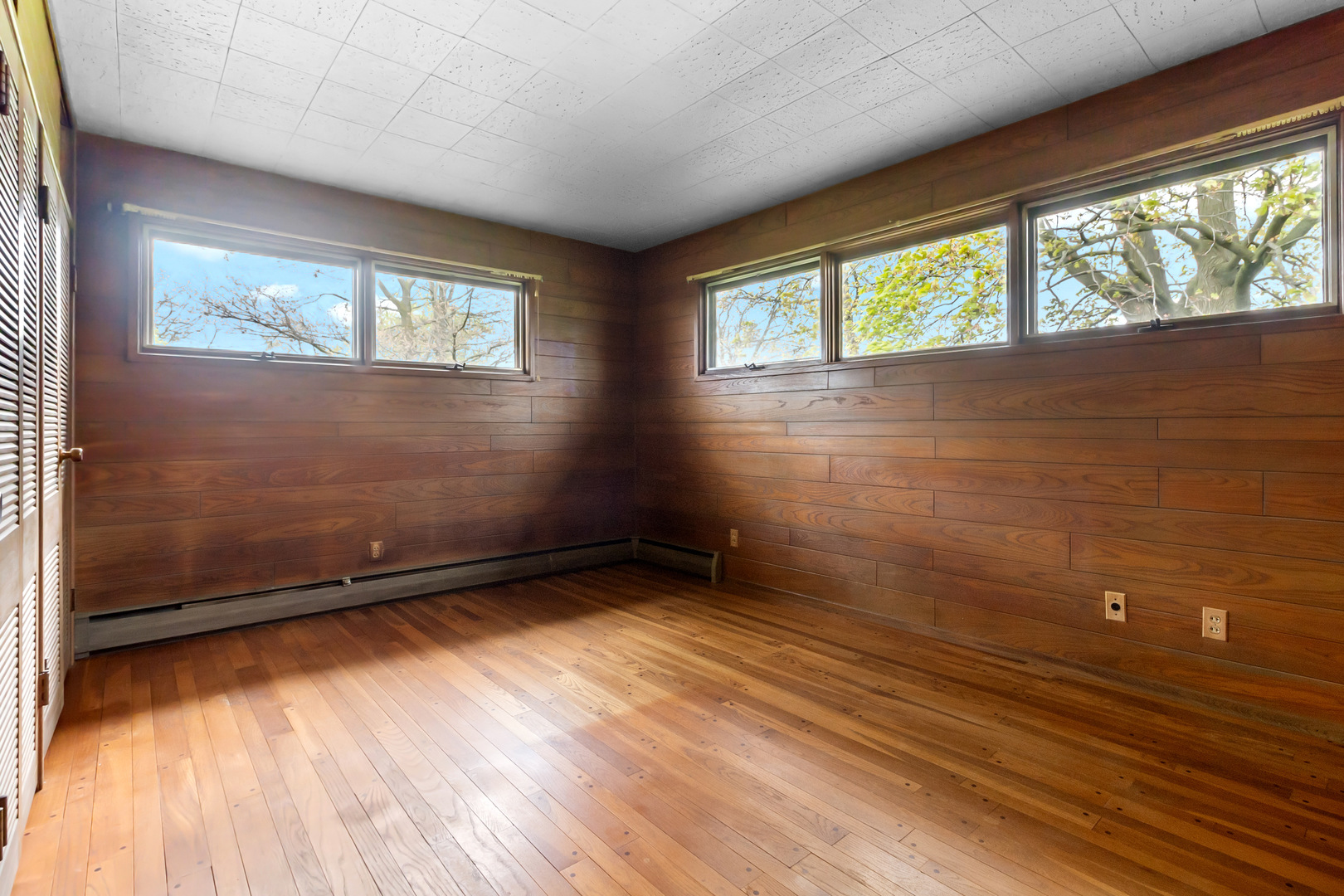 6907 White Oaks Road Harvard, IL 60033 - Photo 8 of 21 an empty room with wooden floor and windows