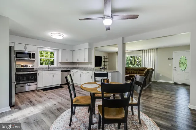 a kitchen with appliances a sink and cabinets