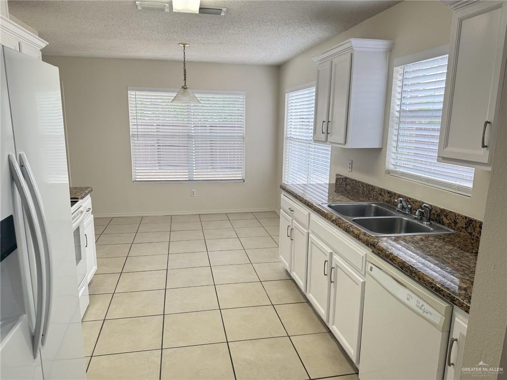 3414 Santa Rocio Mission, TX 78572 - Photo 5 of 19 a kitchen with a sink a stove a refrigerator and cabinets