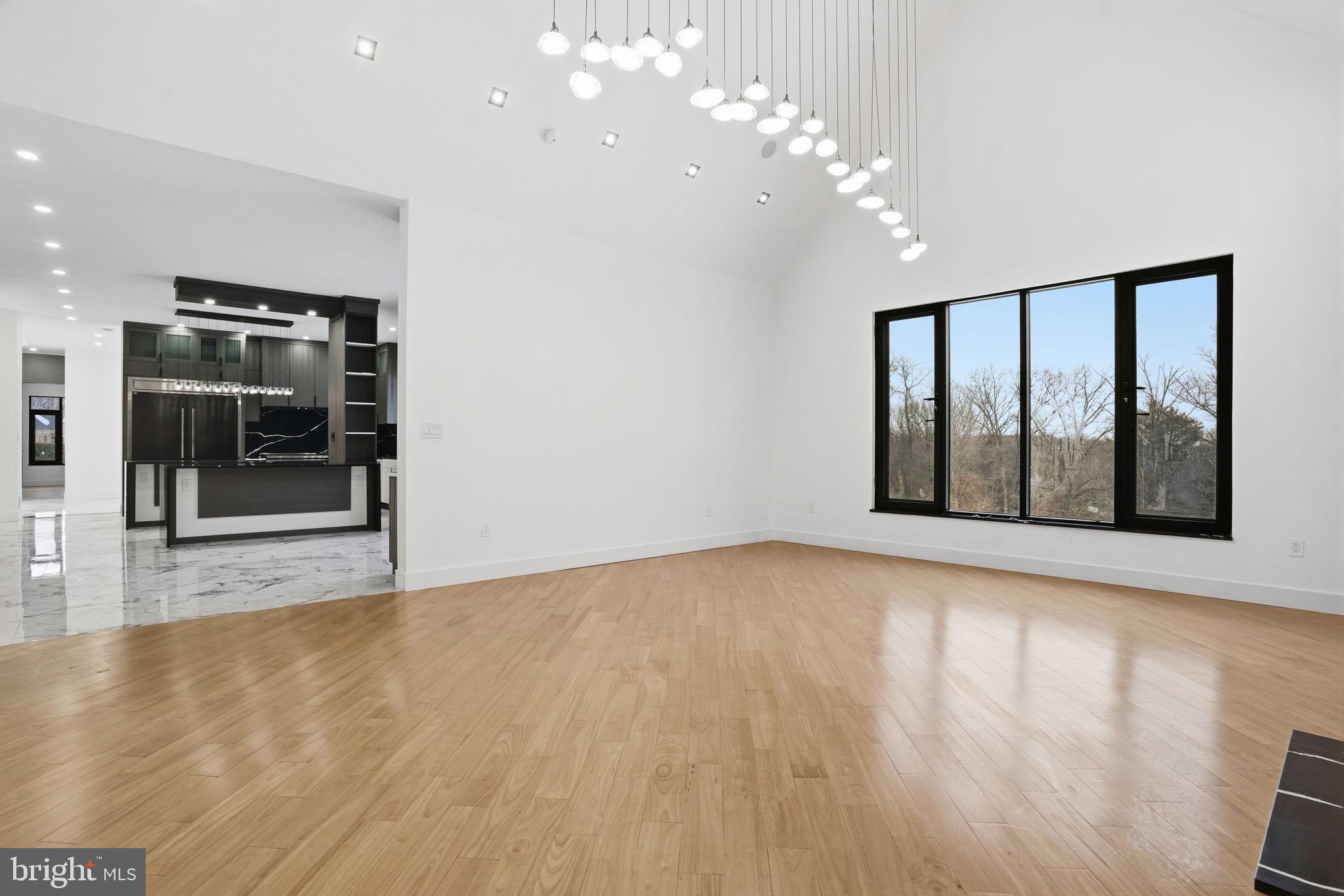 1047 Welsh Road Huntingdon Valley, PA 19006 - Photo 31 of 96 a view of an empty room with wooden floor and a window