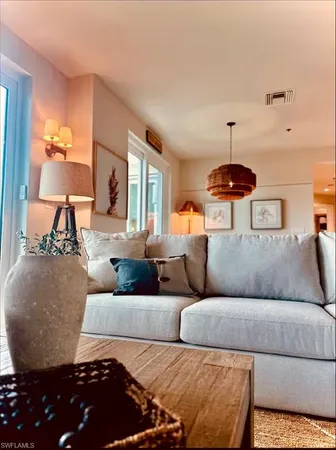 a living room with furniture and a chandelier