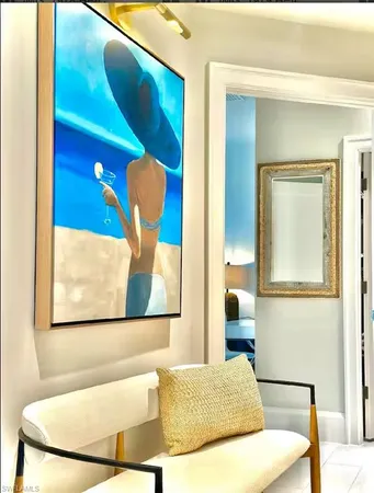 a bedroom with a bed and painting on the wall