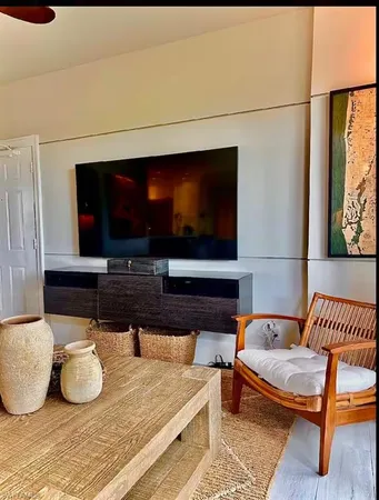 a living room with furniture and a flat screen tv