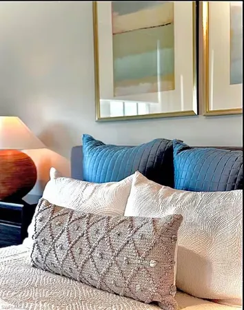 a bed sitting in a bedroom next to a window