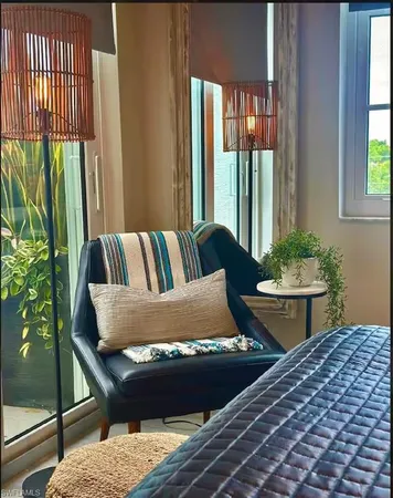 a bed sitting in a bedroom next to a window