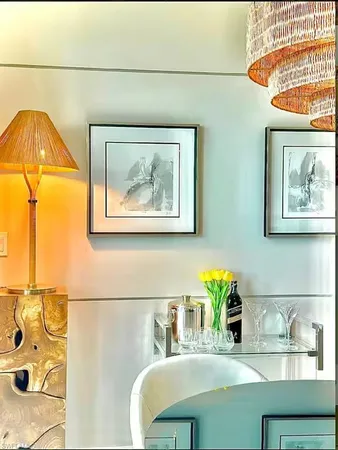 a view of a dining room with a table and chairs