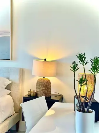 a bedroom with a bed and a potted plant