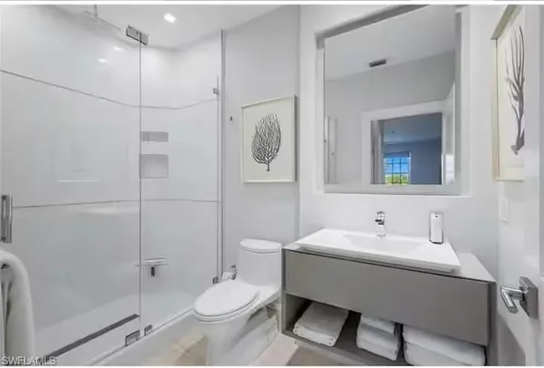 a bathroom with a toilet sink and shower