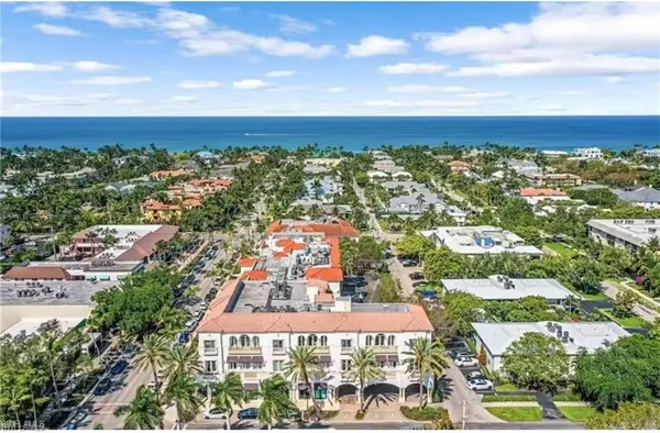 an aerial view of residential houses with city view