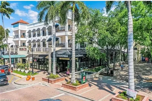 a view of a building with sitting area and garden