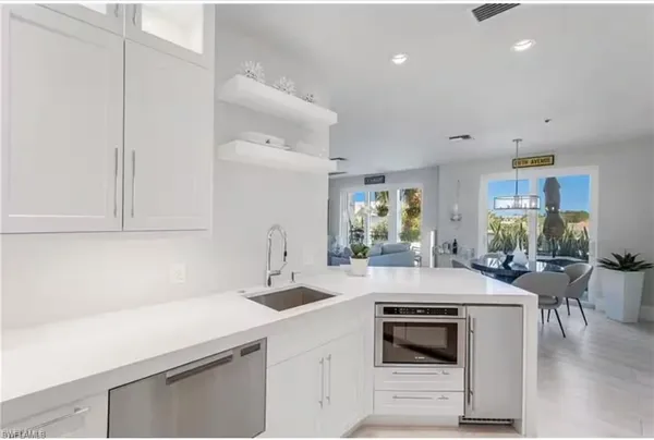 a kitchen with a sink stove and cabinets