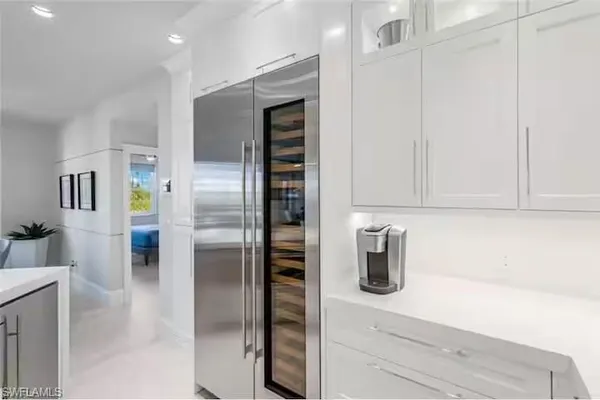 a kitchen with a refrigerator and microwave