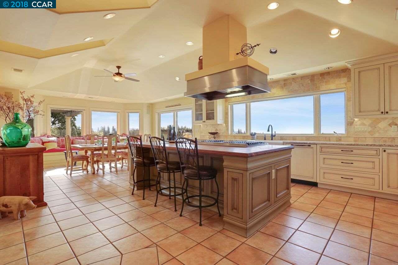 300 Eagle Drive Murphys, CA 95247 - Photo 16 of 40 a kitchen with a cabinets and chairs