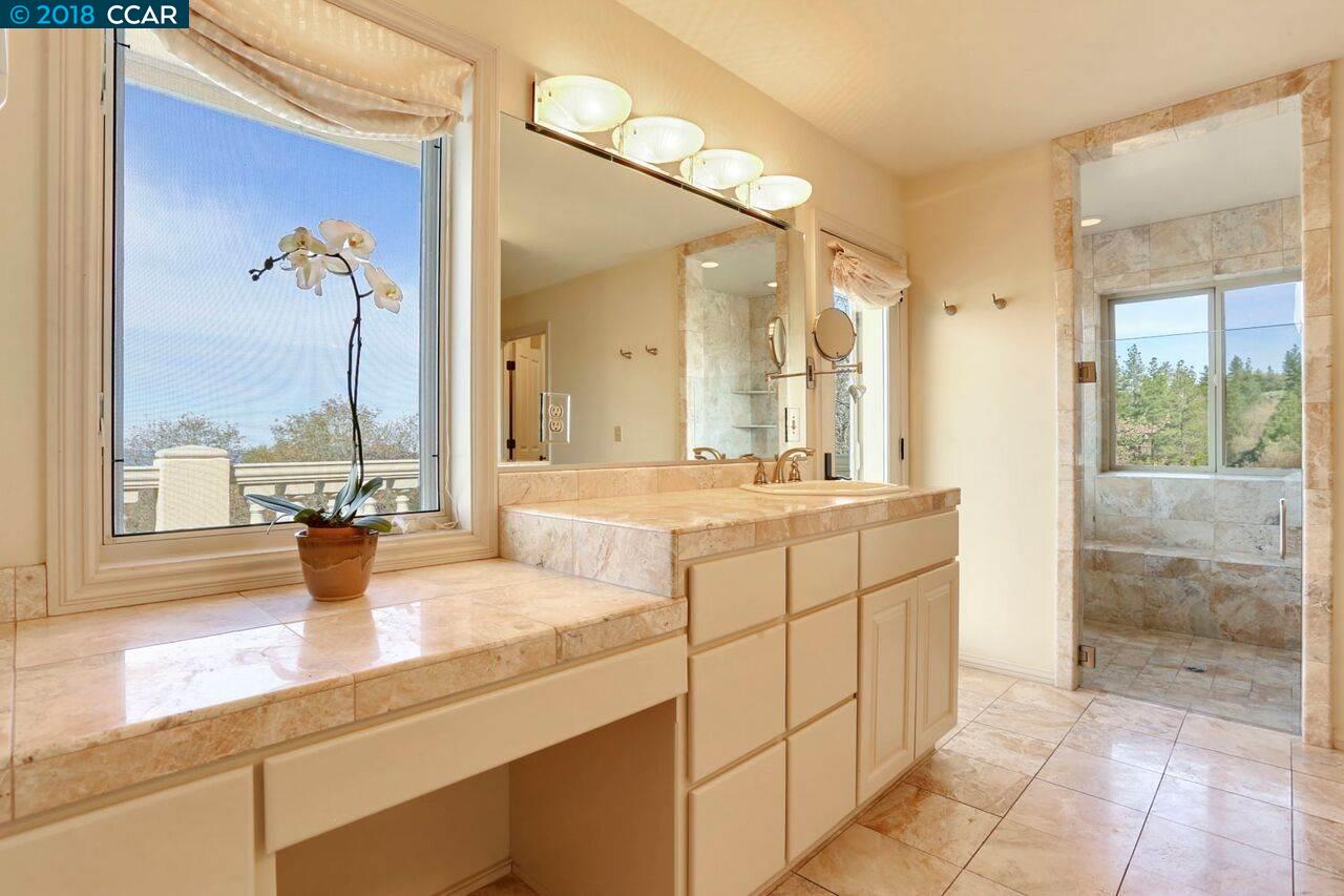 300 Eagle Drive Murphys, CA 95247 - Photo 25 of 40 a bathroom with a double vanity sink and a mirror