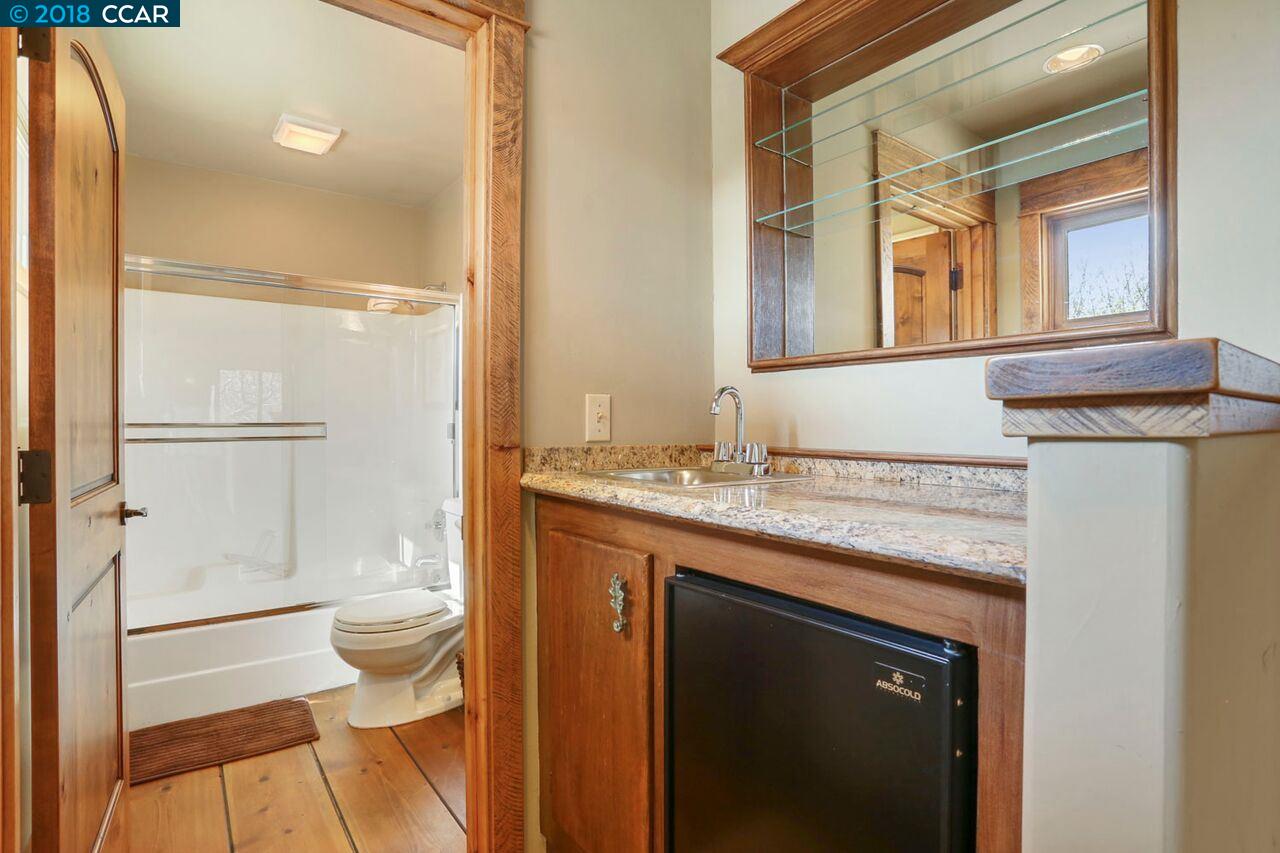 300 Eagle Drive Murphys, CA 95247 - Photo 36 of 40 a bathroom with a granite countertop sink toilet and shower