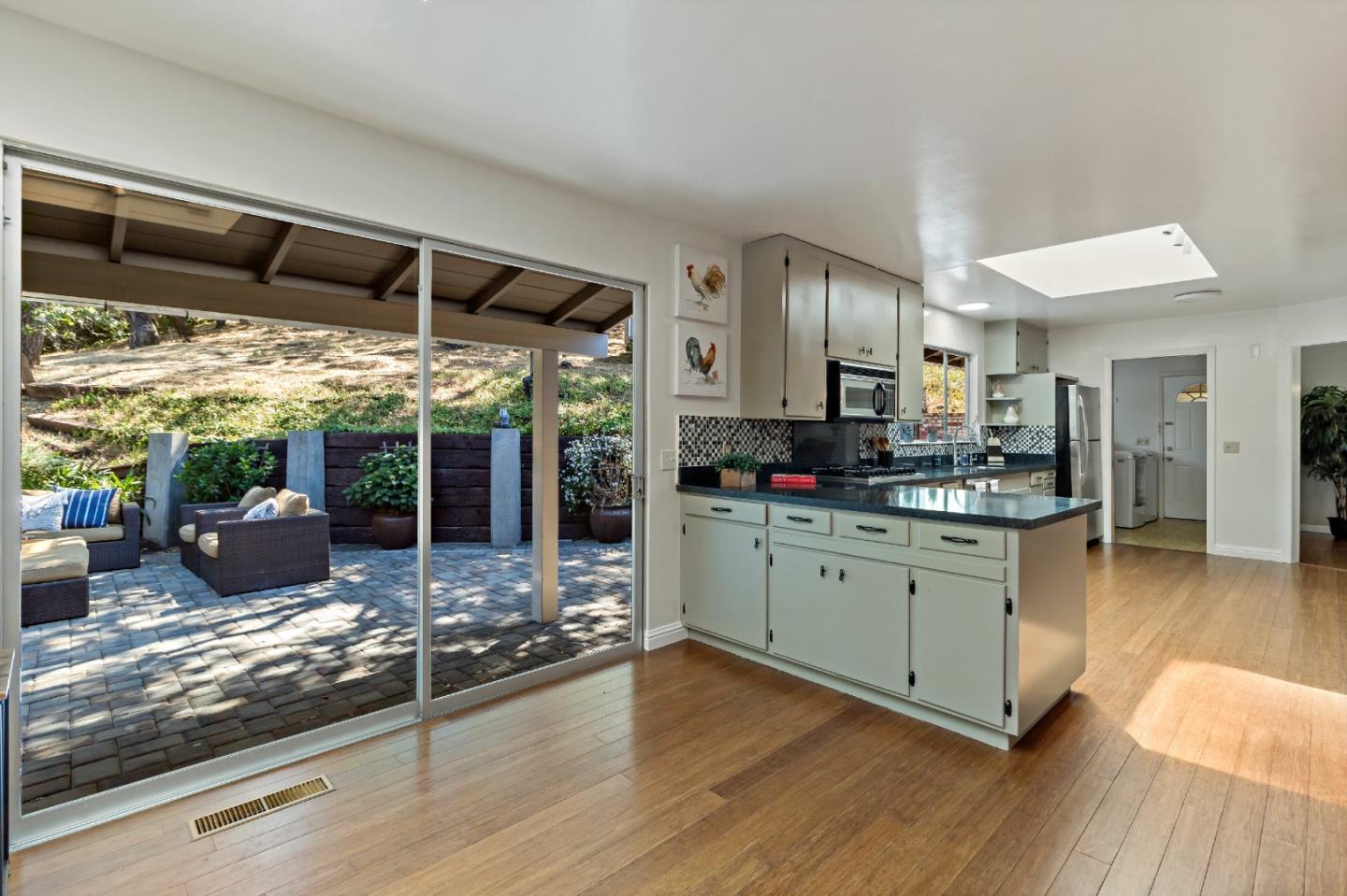 335 Harcross Road Woodside, CA 94062 - Photo 13 of 72 a kitchen with refrigerator and wooden floor