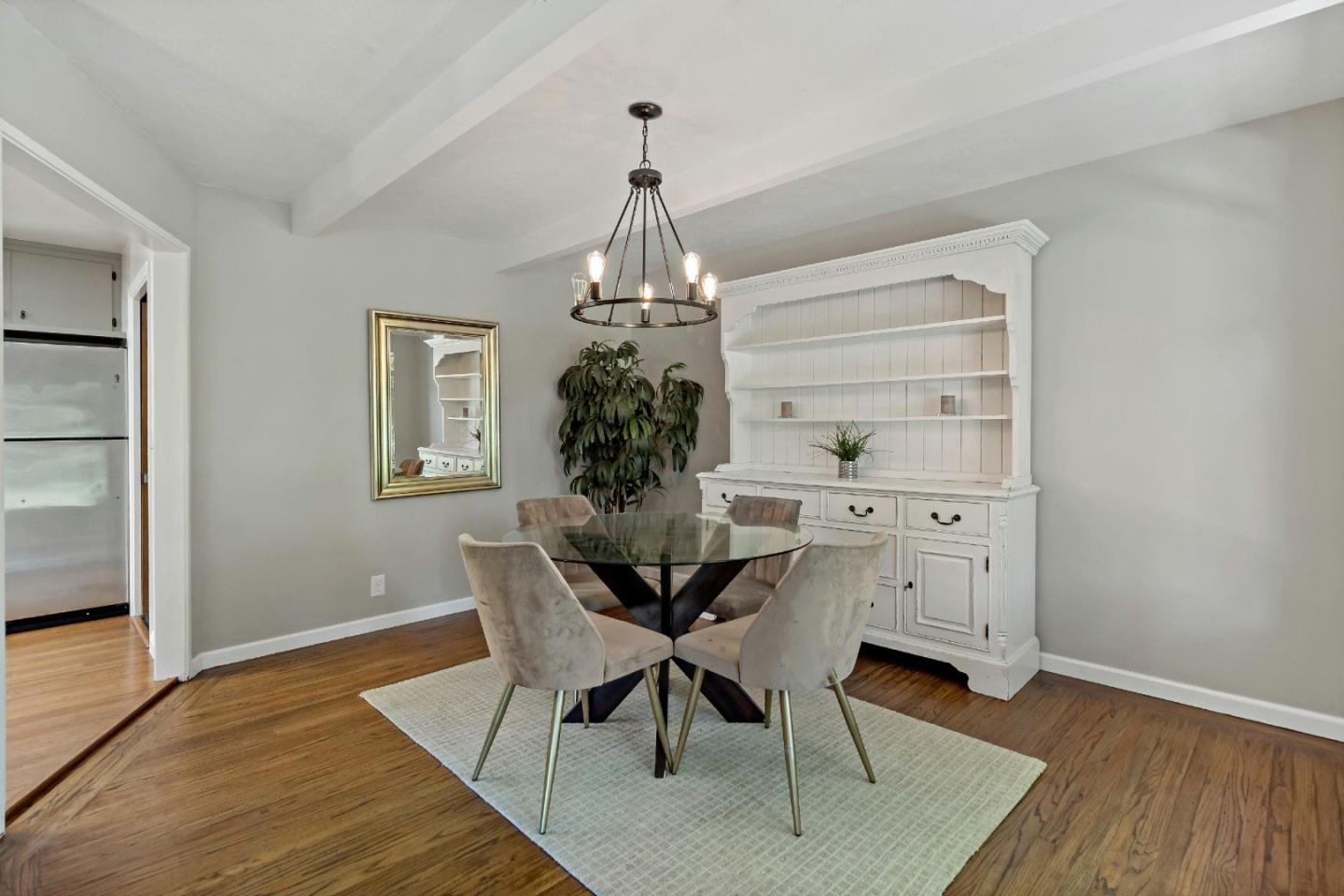 335 Harcross Road Woodside, CA 94062 - Photo 16 of 72 a dining room with wooden floor a chandelier a wooden table and chairs
