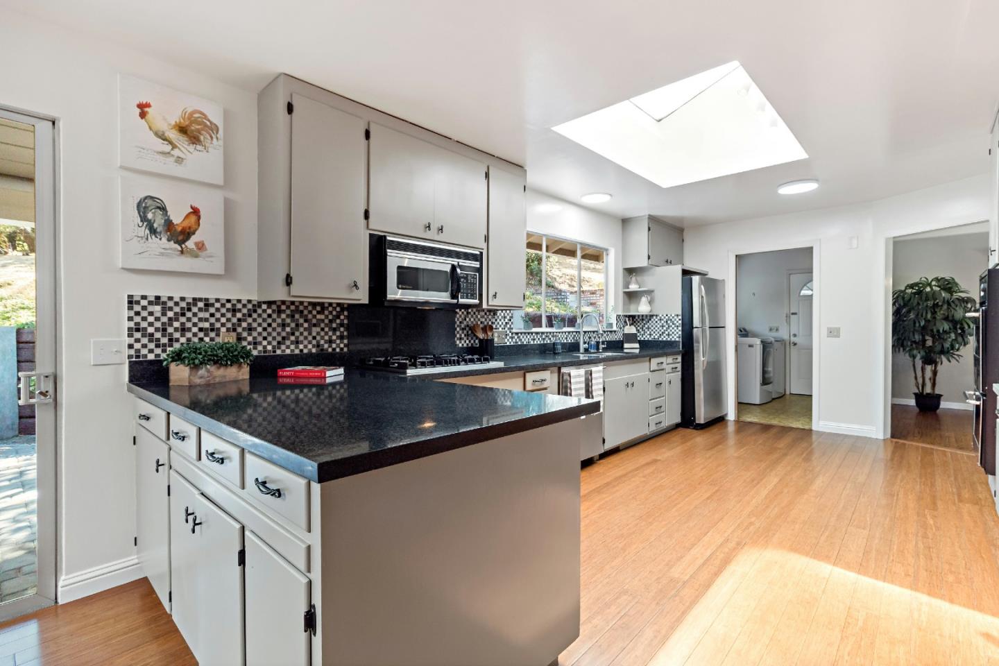 335 Harcross Road Woodside, CA 94062 - Photo 20 of 72 a kitchen with granite countertop a refrigerator sink and cabinets