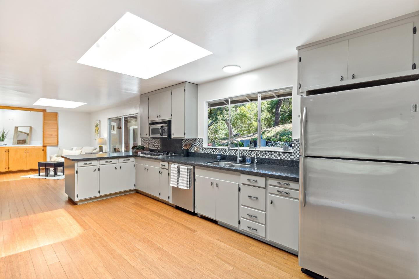 335 Harcross Road Woodside, CA 94062 - Photo 21 of 72 a kitchen with white cabinets and white appliances