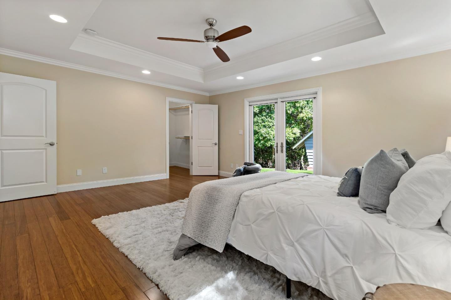 335 Harcross Road Woodside, CA 94062 - Photo 27 of 72 a bedroom with a large bed and a chandelier