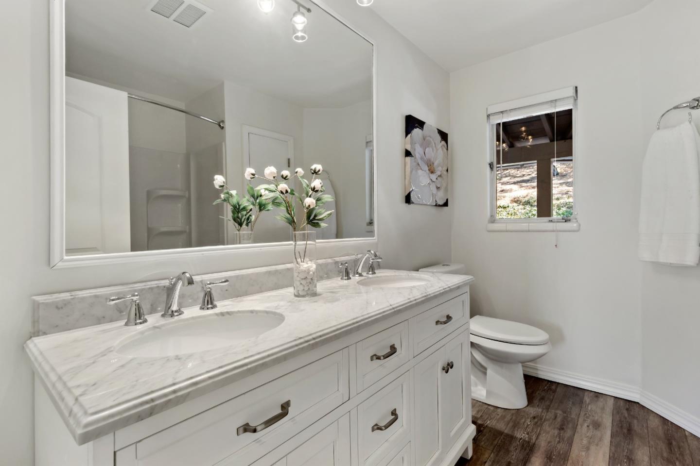 335 Harcross Road Woodside, CA 94062 - Photo 34 of 72 a bathroom with a granite countertop sink a toilet and a mirror