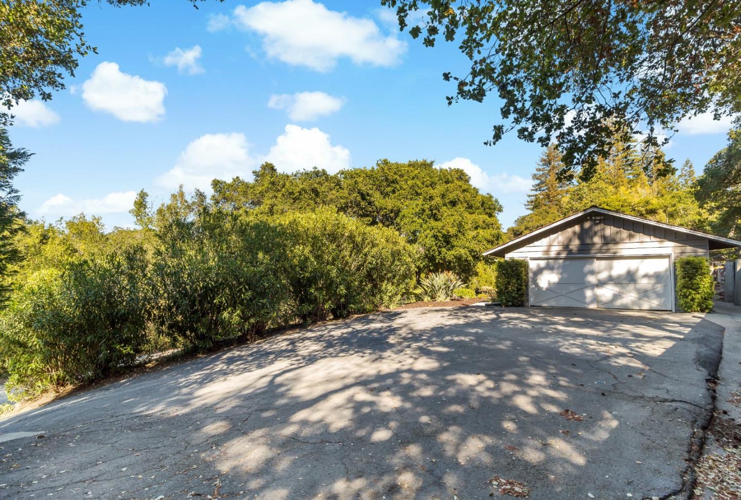 335 Harcross Road Woodside, CA 94062 - Photo 44 of 72 a view of a large house with a big yard and large trees