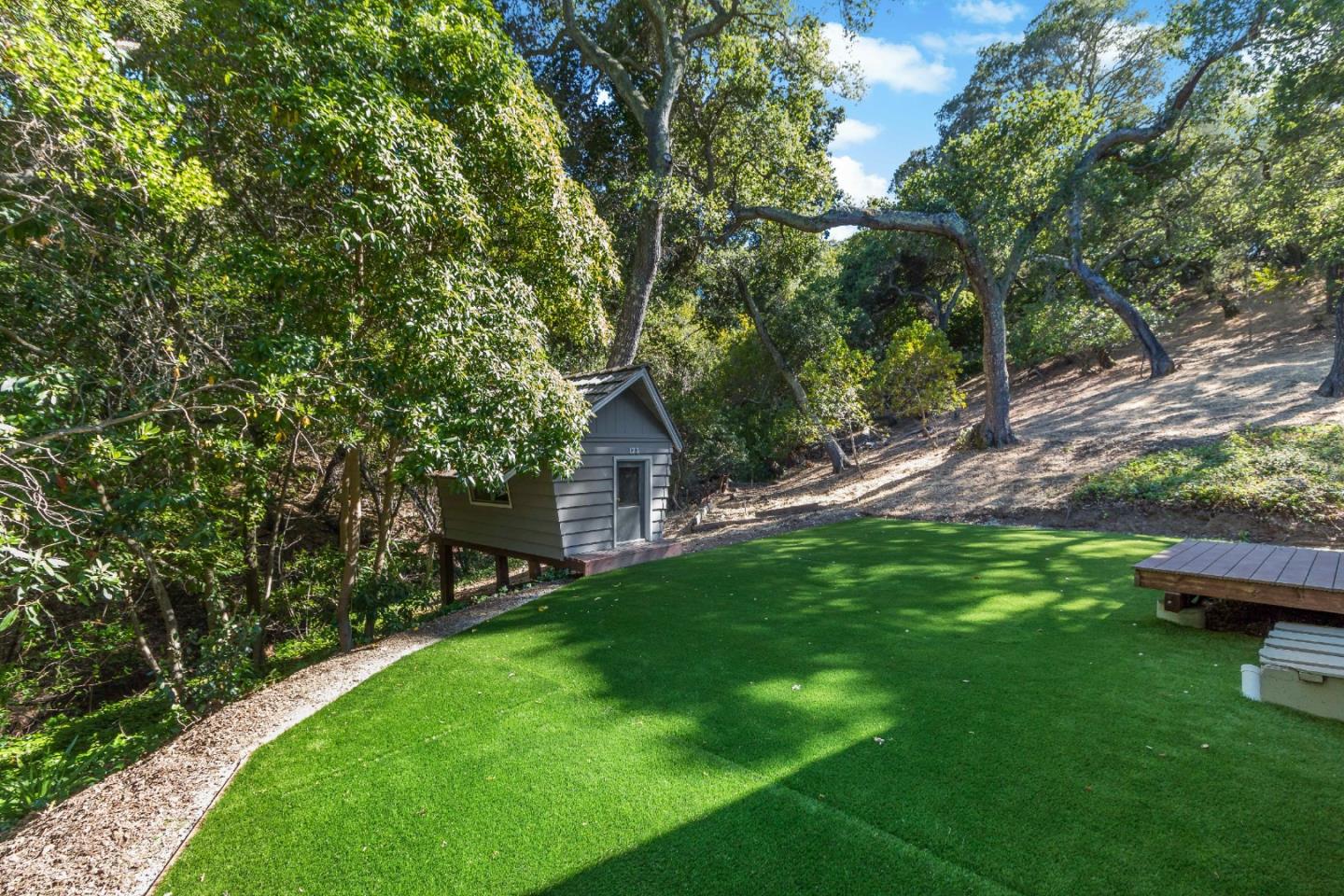 335 Harcross Road Woodside, CA 94062 - Photo 46 of 72 a view of a backyard with wooden fence and a bench